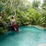 Woman sitting by a pool in Bali