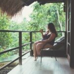 Woman drinking coffee on a balcony in Bali