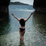 Joyful woman with her hands in the air at Angel's Billabong Nusa Penida Photo Location