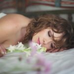 Serene boudoir photo of nude woman in Bali with flowers
