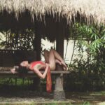 Bali boudoir photo of woman lounging on outdoor Bali bed