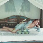 Beautiful woman lounging on a bed in Bali