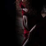 Dramatic boudoir photo of strong black woman showing stretchmarks