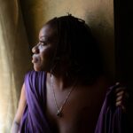 Beautiful boudoir photo of curvy black woman with locs